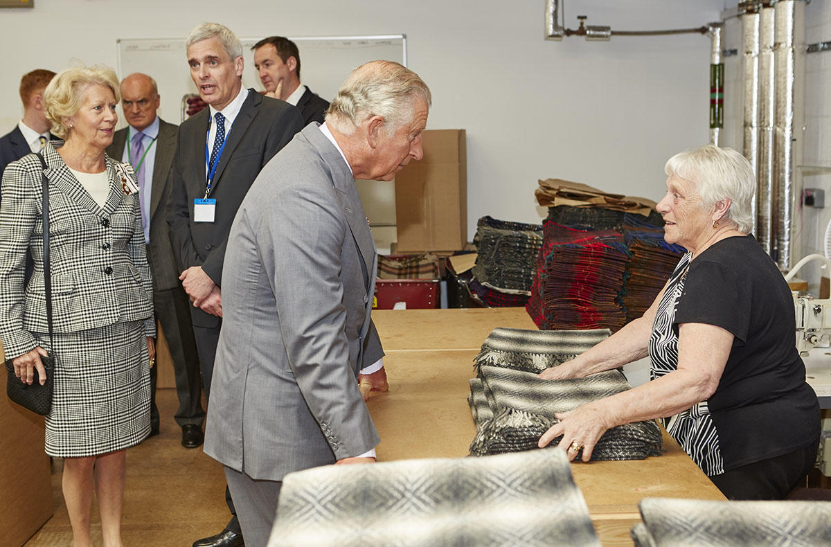 Kevin Cockerham, Production Manager of Abraham Moon and Sons is pictured above behind Prince Charles discussing wool at a Campaign for Wool event in Leeds